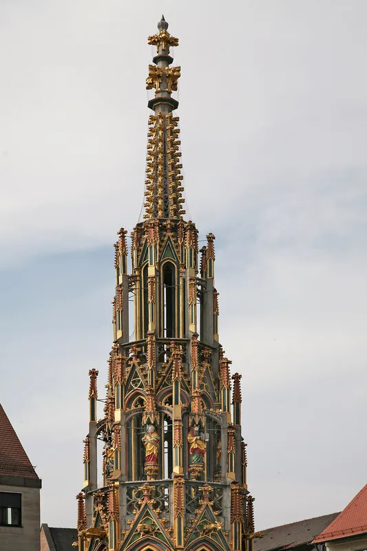 The Schöner Brunnen, the gilded gothic fountain spire on the Hauptmarkt
